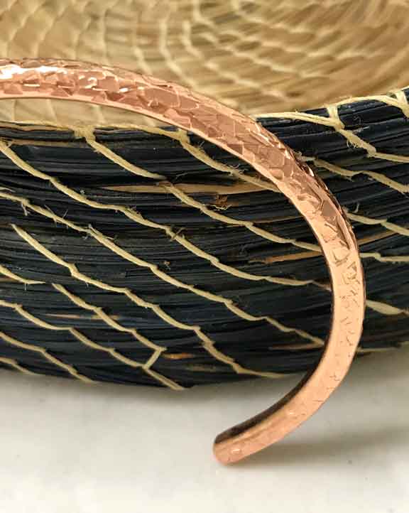close up of textured handmade copper bracelet